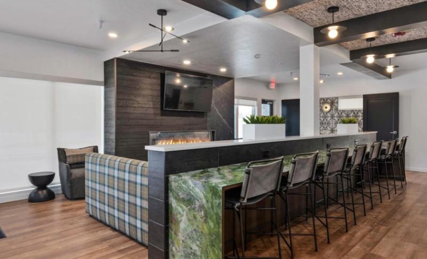 Access to resident-only features a room with a bar and chairs