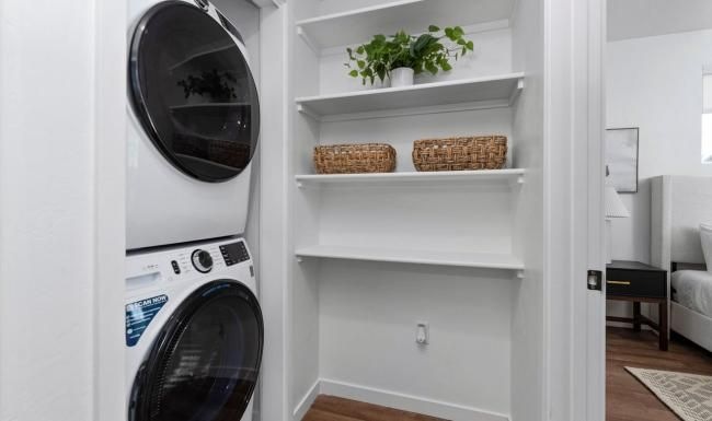 Laundry has never been easier a white shelving unit with a basket and a basket on it