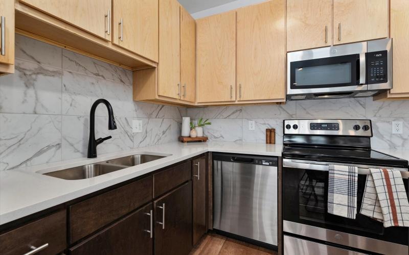 a kitchen with wooden cabinets