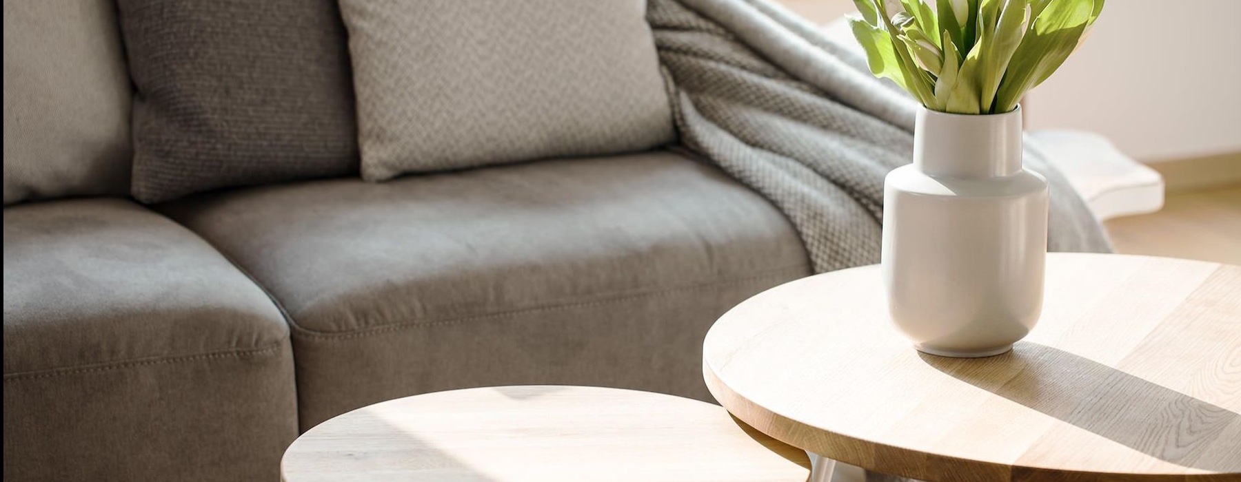 a living room with a couch and tables